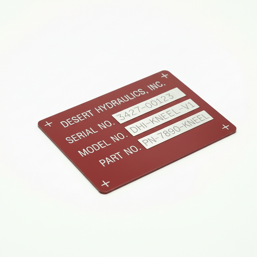 Anodized aluminum metal tag with Desert Hydraulics, Inc. information on a white background